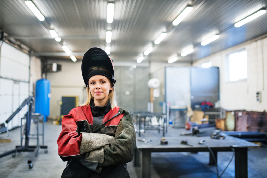 Welder standing in front of the workshop.
